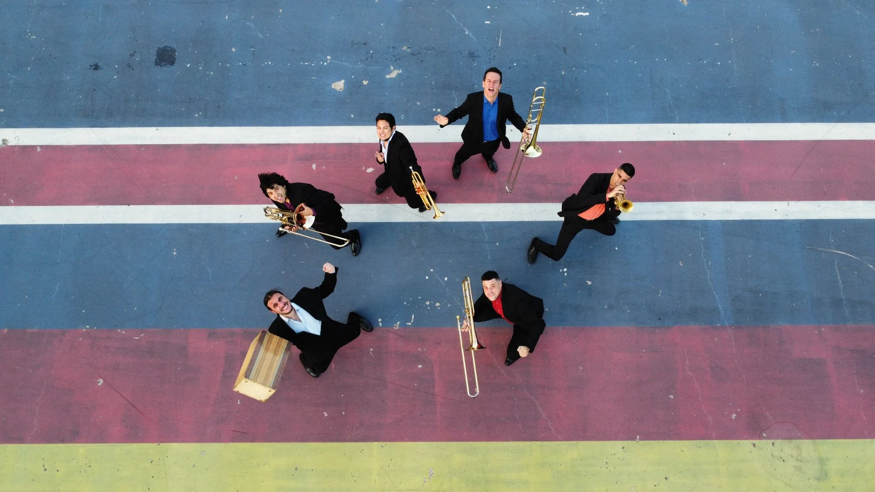 Iberoamerican Ensemble photographed from above on a colourful court